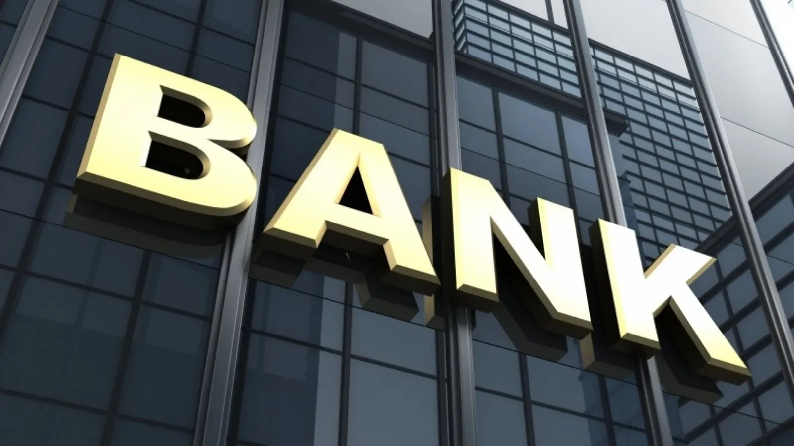 Gold BANK letters on a glass office building facade